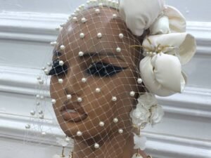 Home The cream ruffled pearl fascinator is a unique piece of headgear, made to elevate the woman's elegance.